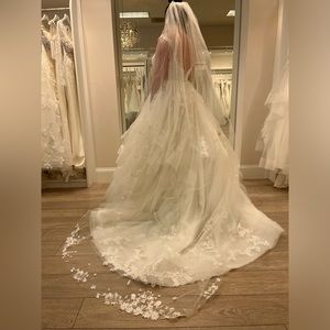 Beautiful ivory lace and tulle wedding dress, with delicate clear beading.